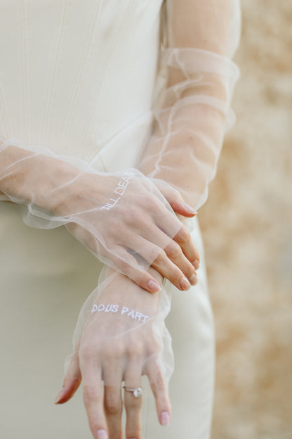 sheer white bridal glove sleeves set on bride wearing corset gown