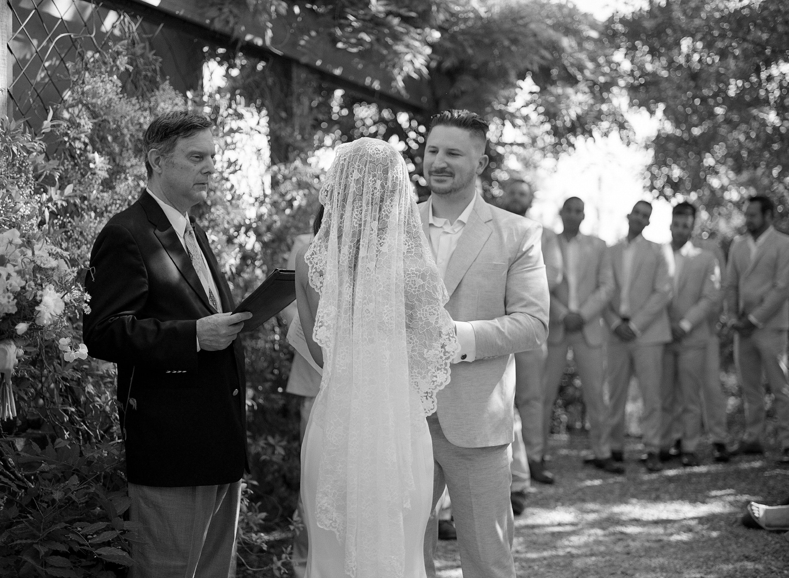 Load video: Mexican destination wedding with bride walking down aisle in long lace cathedral bridal veil mantilla style