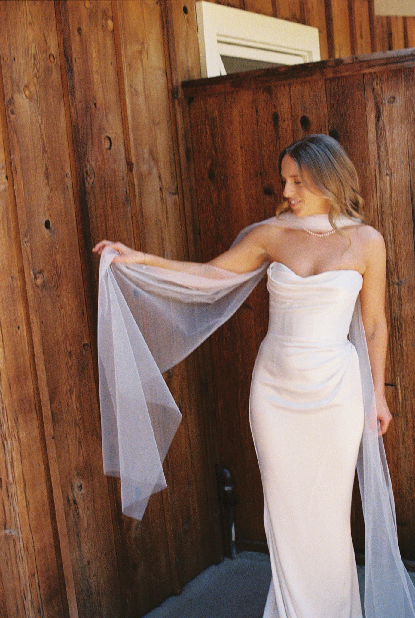 simple elegant and chic tulle bridal scarf with pearl necklace on bride in corset wedding dress