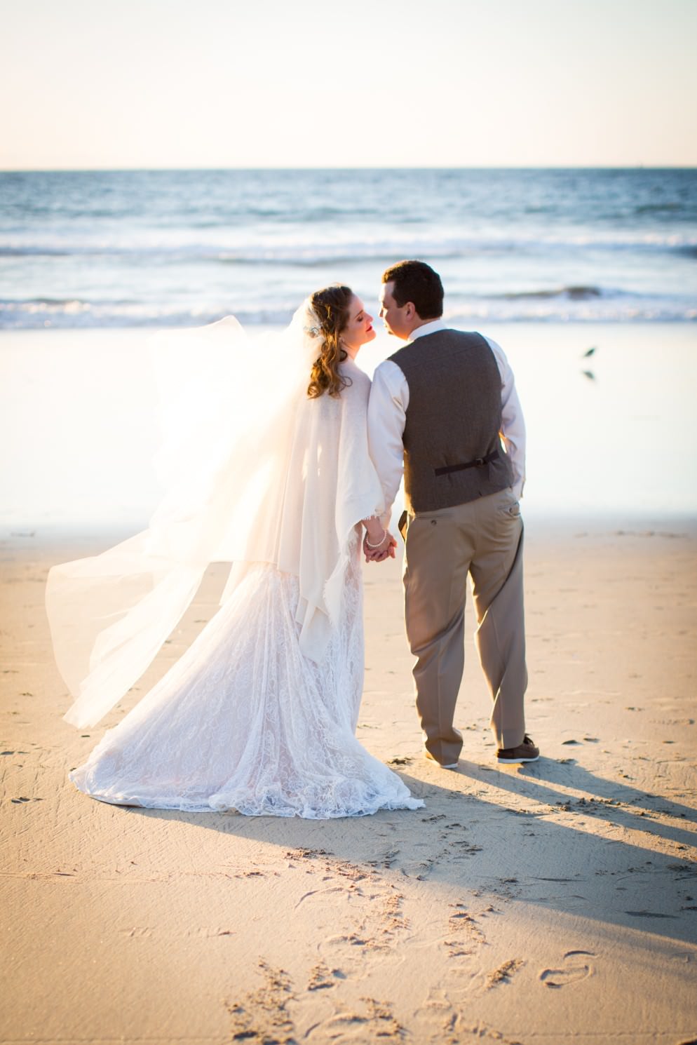 destination beach wedding with floor length blush Juliet cap wedding veil