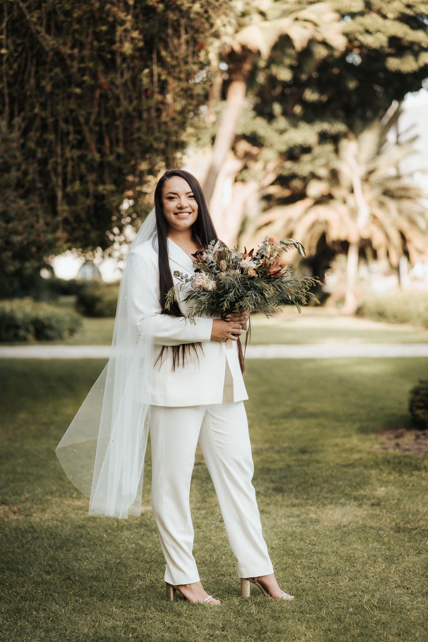 santa barbara bride wearing mid length ivory wedding veil with crystals and beads