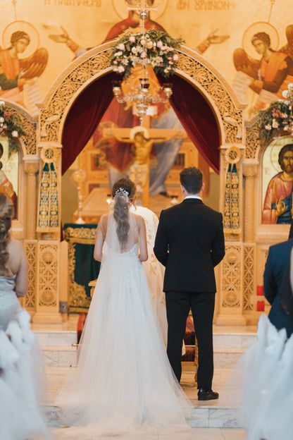 orthodox church wedding with chic curled pony accented with pearl wedding veil and flowers