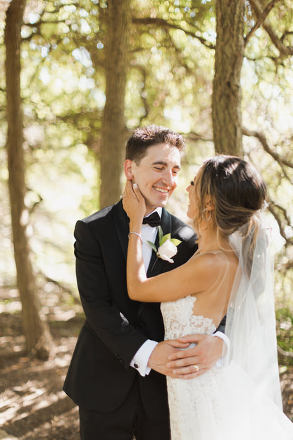 loose curled ponytail bridal hairdo with scattered pearl wedding veil wrap