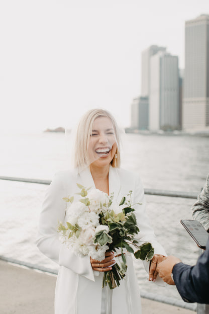 simple raw edge birdcage wedding veil and white pantsuit in New York