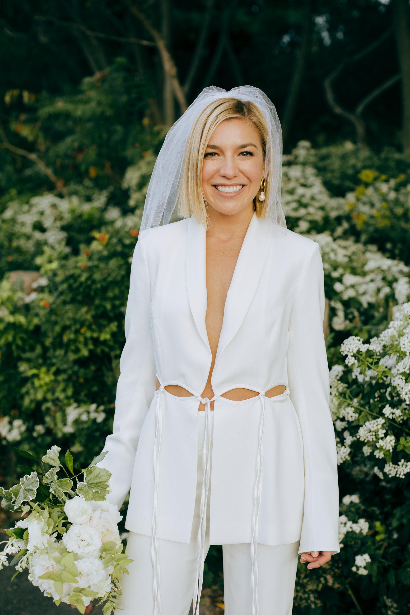 modern shoulder length wedding veil with white bridal pantsuit