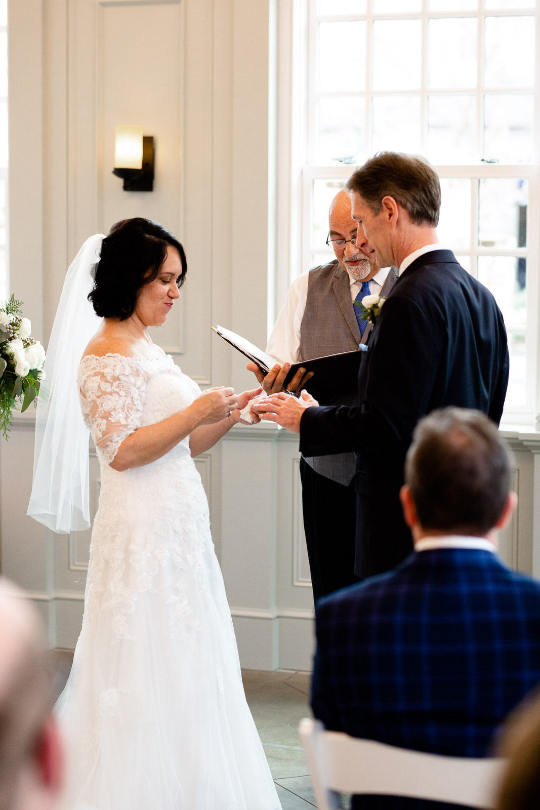bride in lace dress with 3/4 sleeves and short elbow length bridal veil