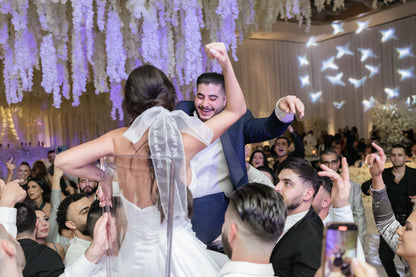 bride and groom dancing with romantic phrase written on hair bow