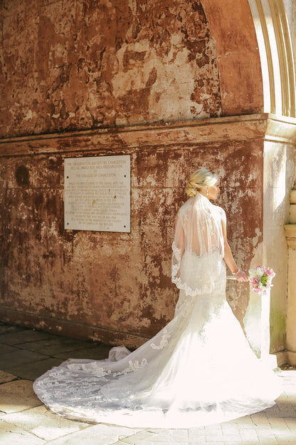 Bridal Portrait of Dress with Long Train and Short Elbow Length Wedding Veil