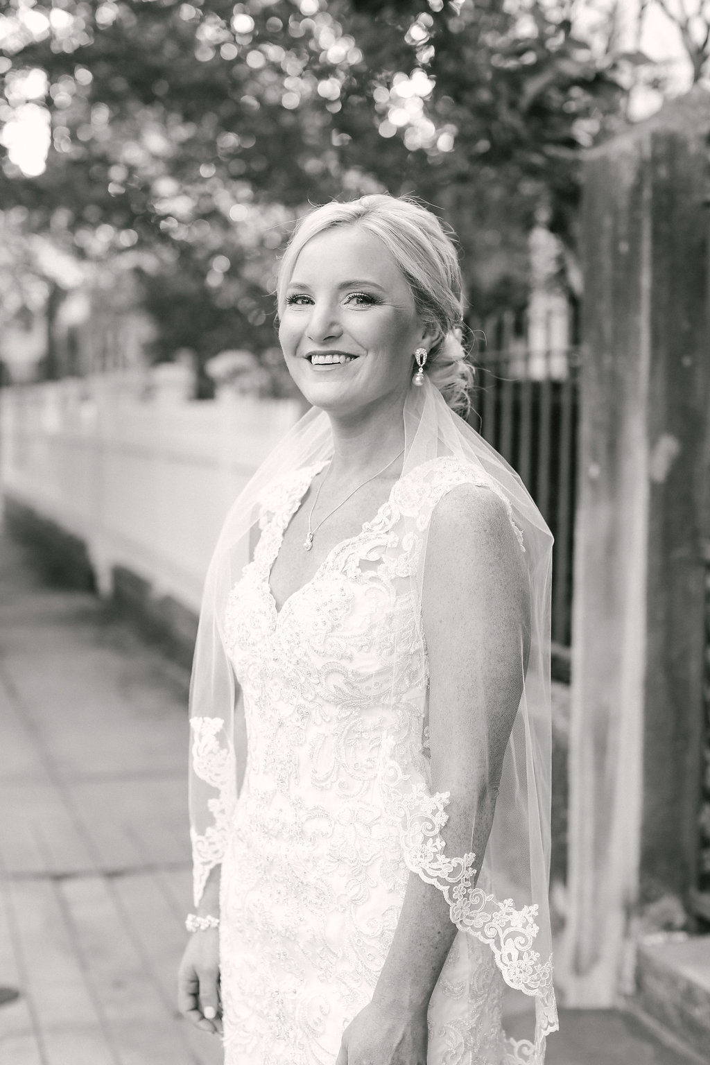 Beauty Portrait of Bride in Lace Wedding Dress and Scalloped Veil