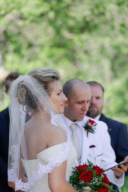 winter bride in elbow length french lace veil over updo