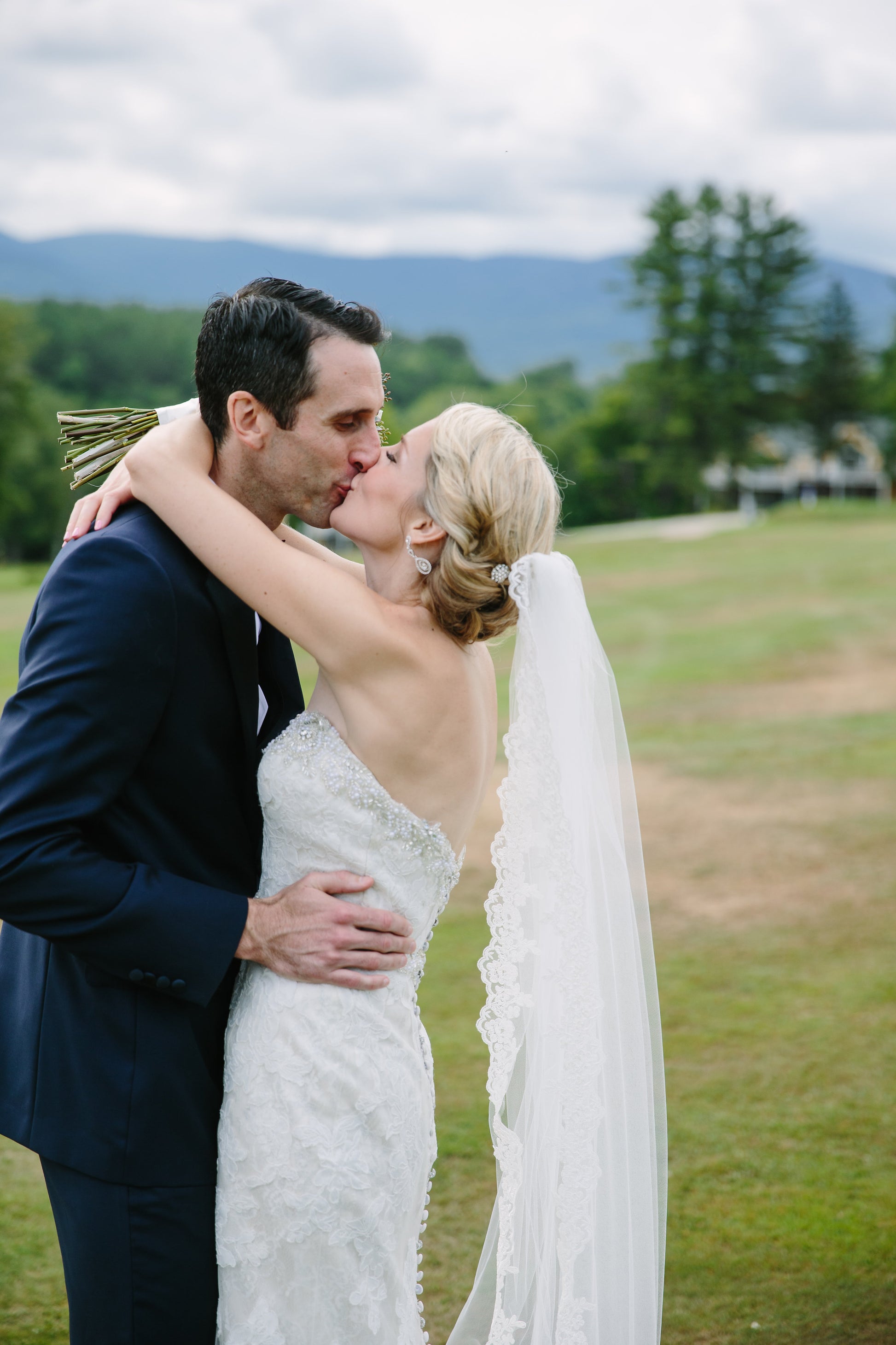 Outdoor Woodsy Romantic Wedding with Bride and Groom Kissing