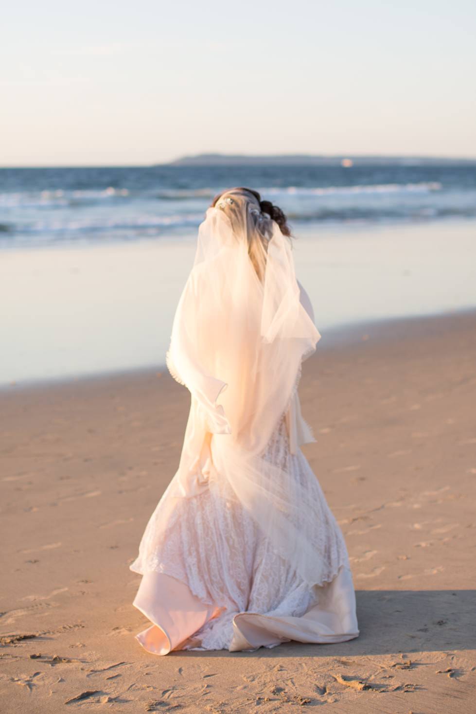 bride in juliet cap waltz length veil for beach wedding 
