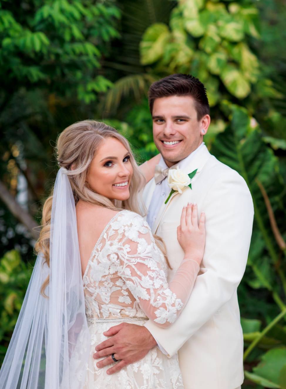 tropical beach wedding with blonde bride wearing draped cape veil in white tulle