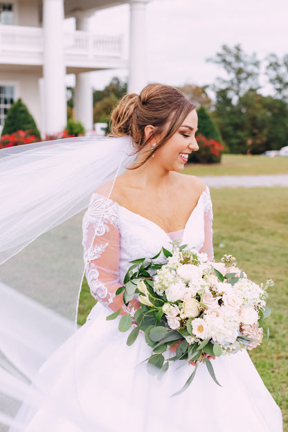 beaded edged wedding veil underneath elegant updo