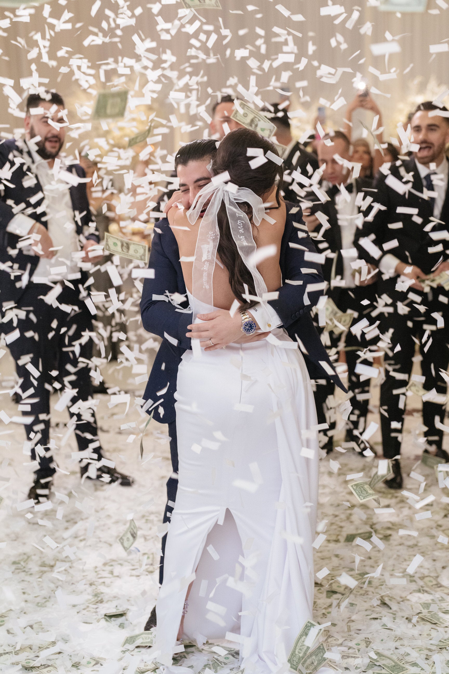 confetti and money toss with bride wearing white hair bow