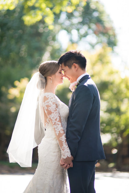 lace long sleeved wedding dress with midlength simple bridal veil