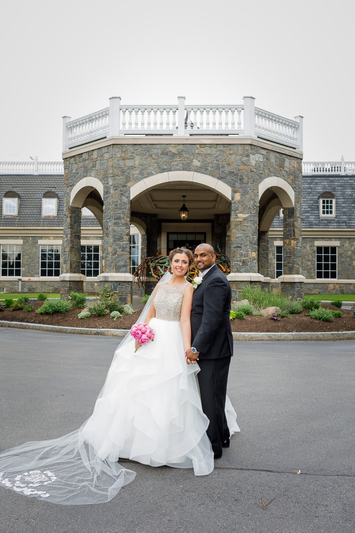 formal castle wedding with bride in ballgown and long monogrammed veil