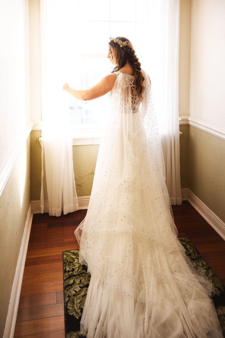 sparkly star bridal cape cathedral length with romantic braid hairstyle