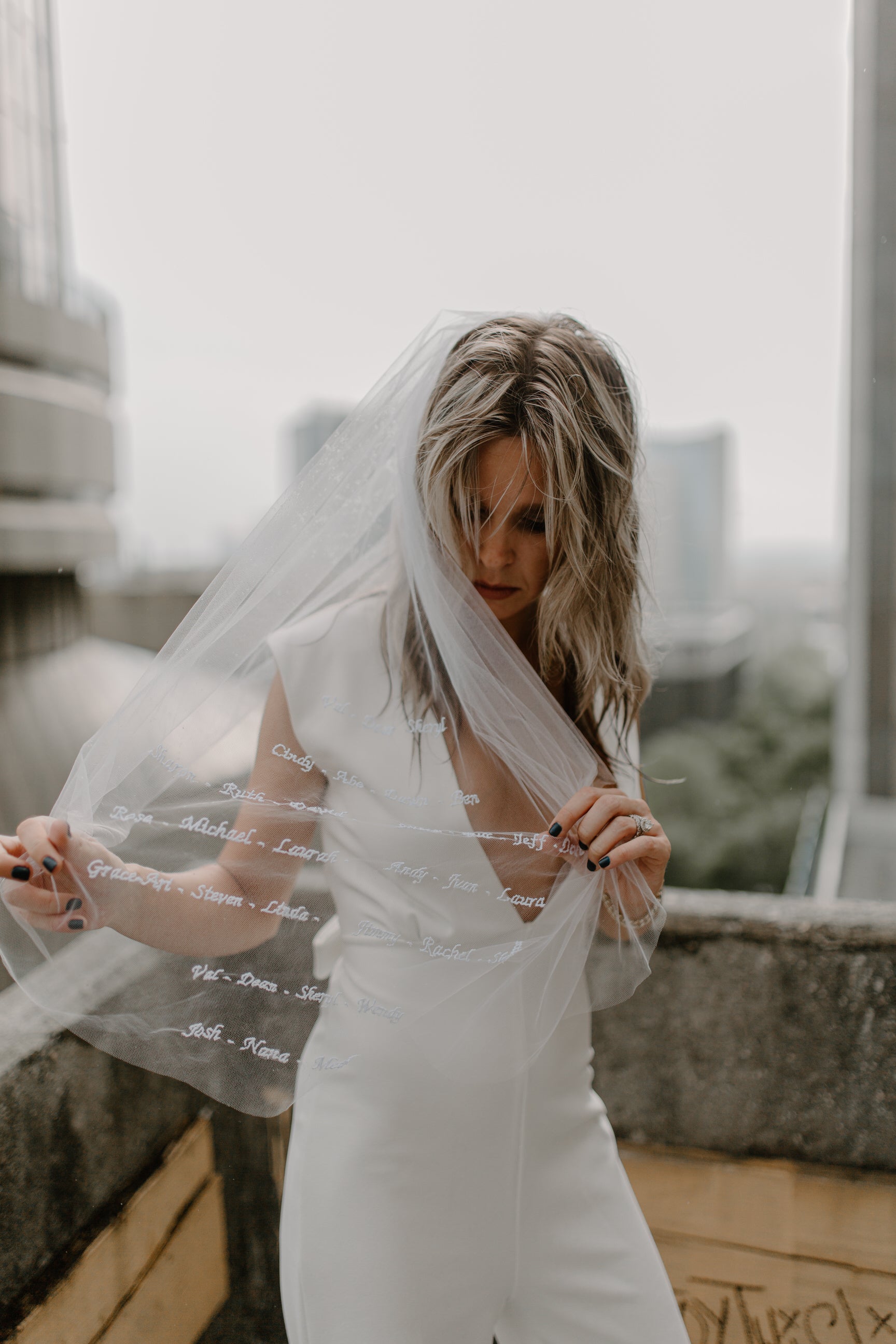 bridal short sleeved jumpsuit and cursive bridal veil waist length