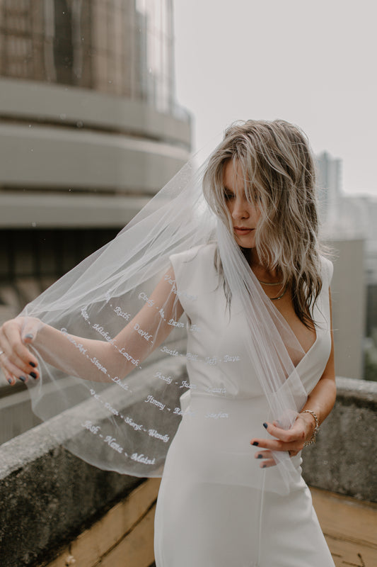 casual deep V neck wedding jumpsuit and heirloom embroidered wedding veil with custom text and writing 