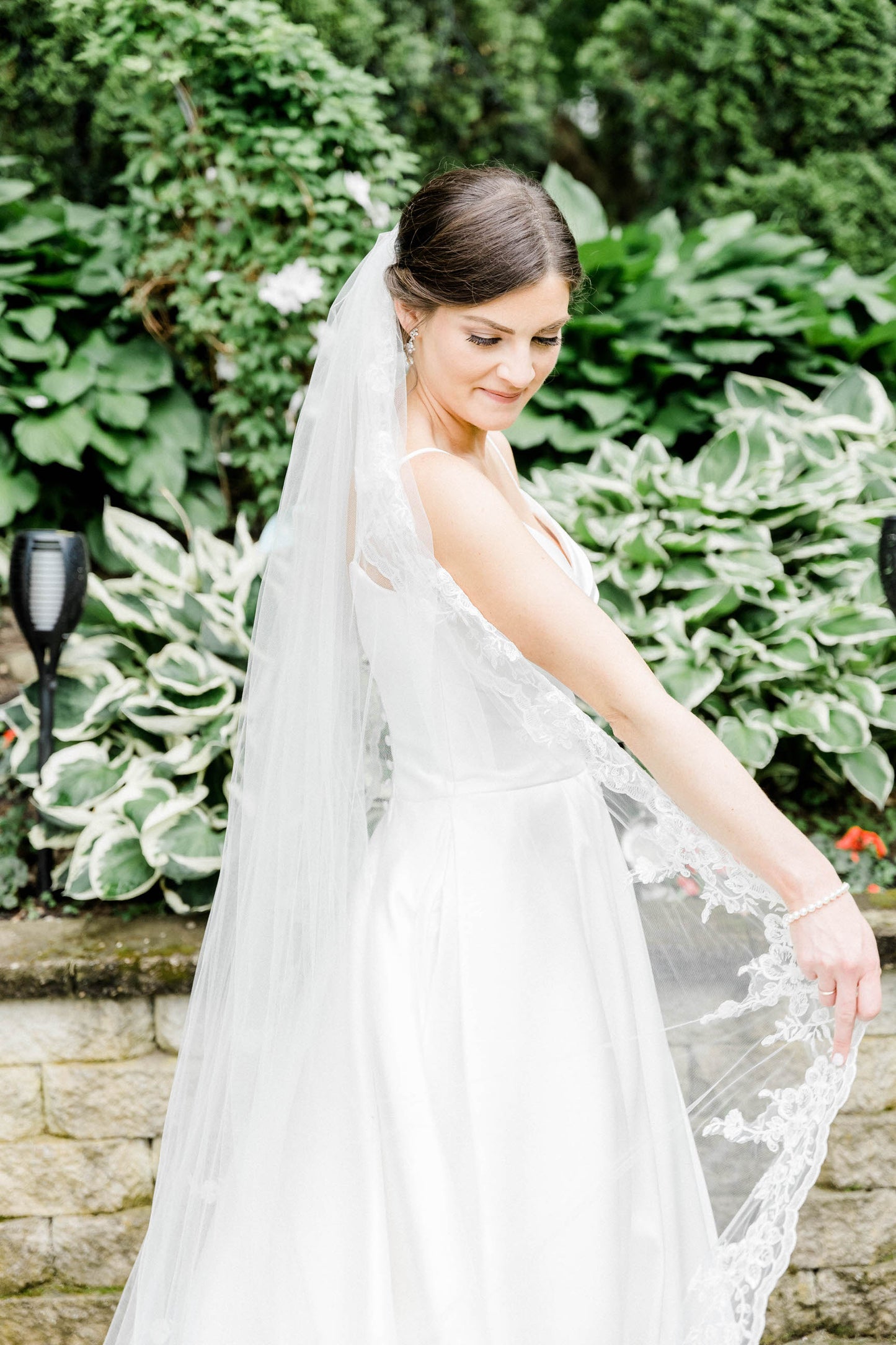 classy long cathedral length bridal veil with lace trim on bride over low updo with mikado A line bridal gown