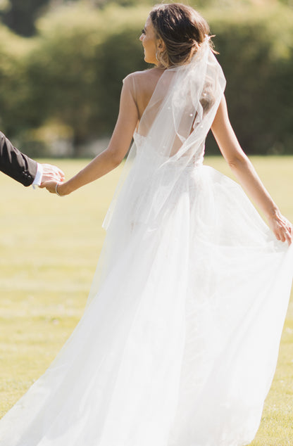 whimsical bride in ponytail wedding veil with pearls