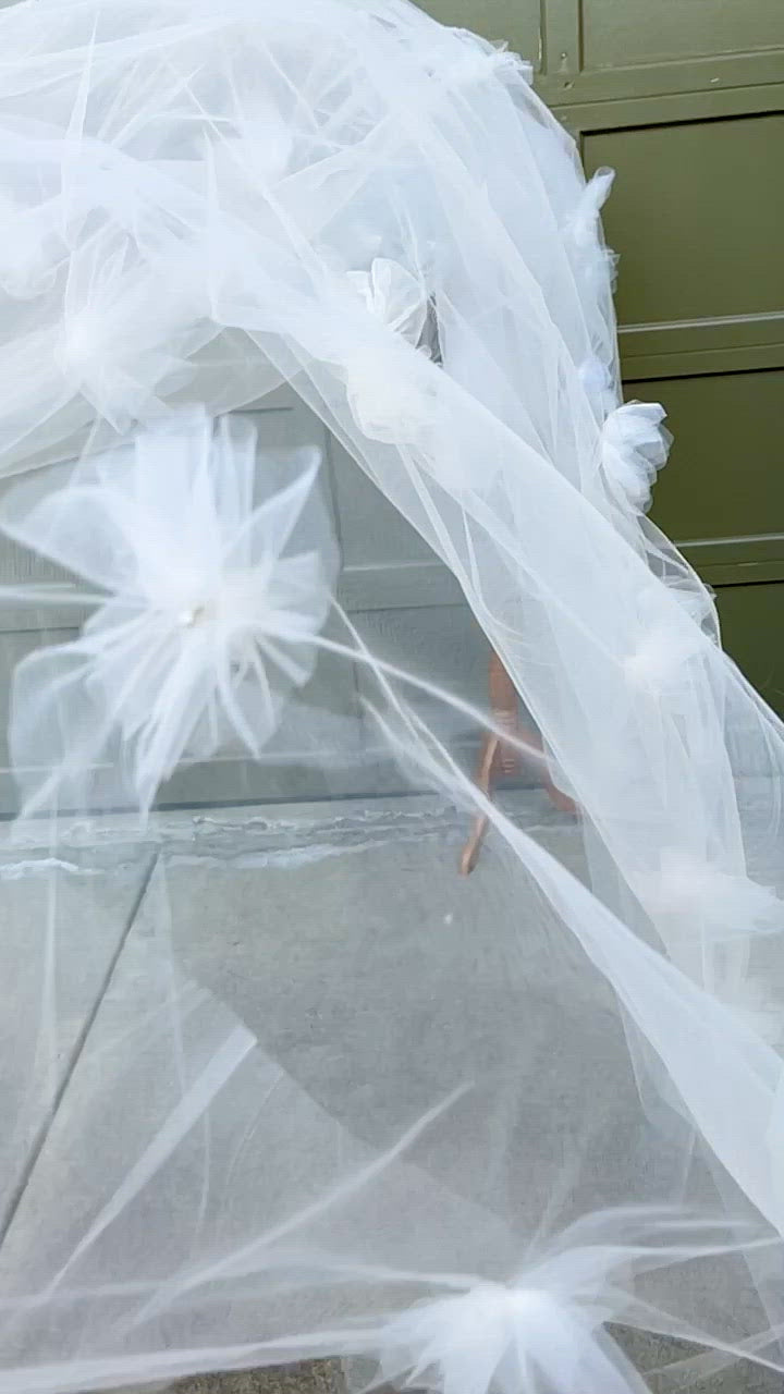 long cathedral length wedding veil with soft handmade flowers scattered through the tulle