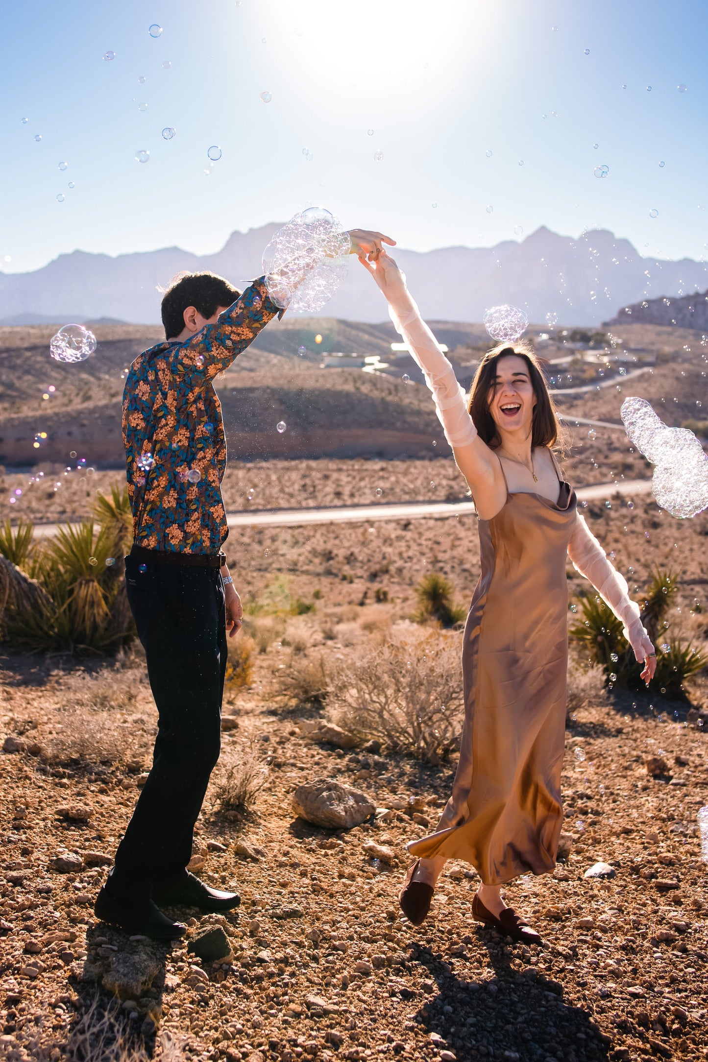 gold desert engagement photo featuring long white fingerless gloves with Tull death embroidery