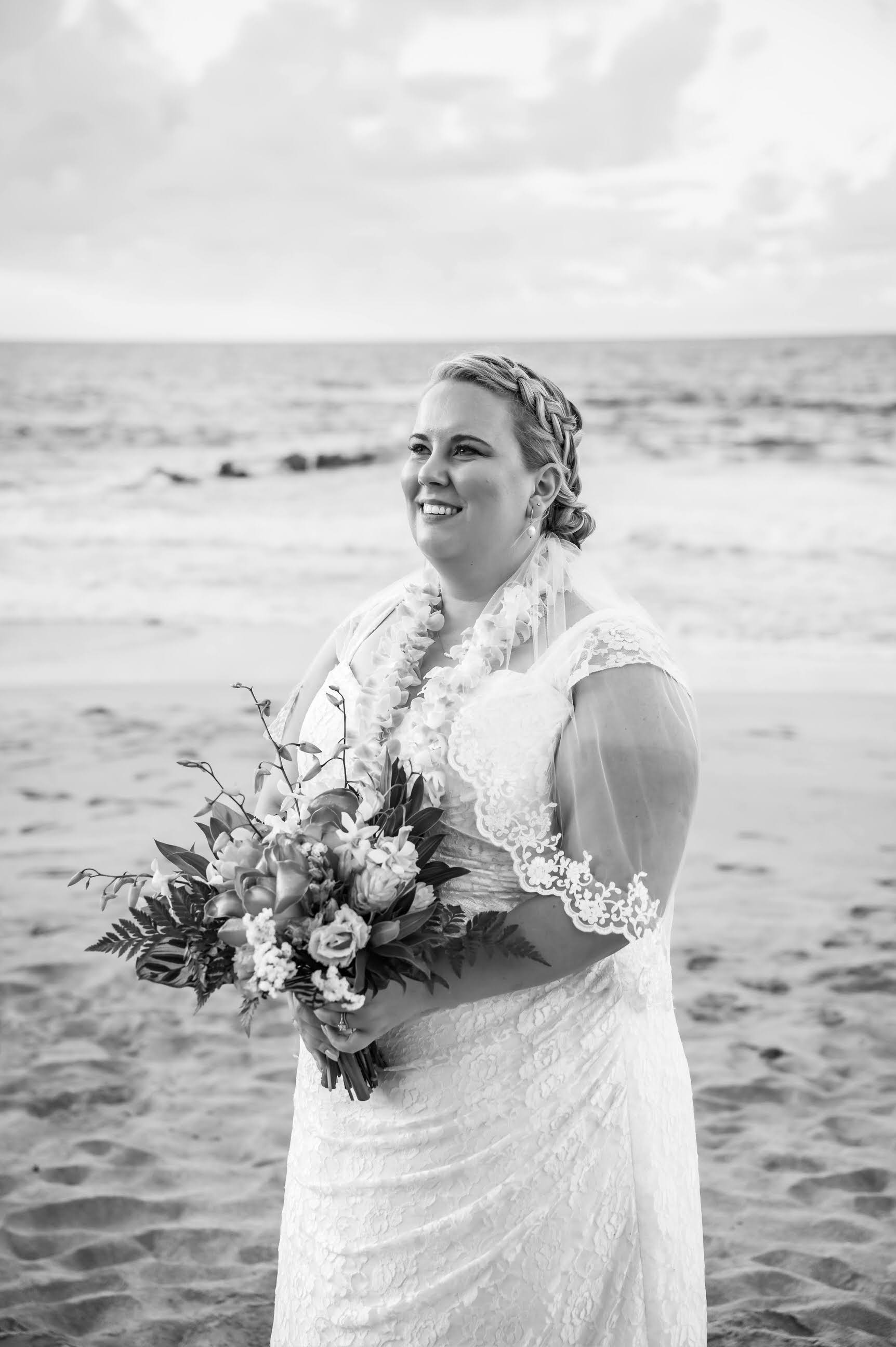 tropical beach wedding with braided bridal updo and elbow length lace bridal veil