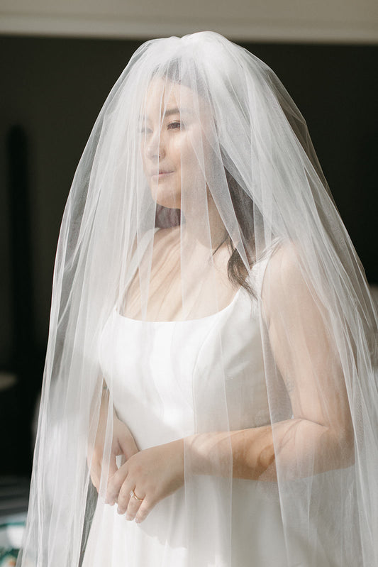classic bride in extra full blusher wedding veil in ivory and scoop neckline crepe gown