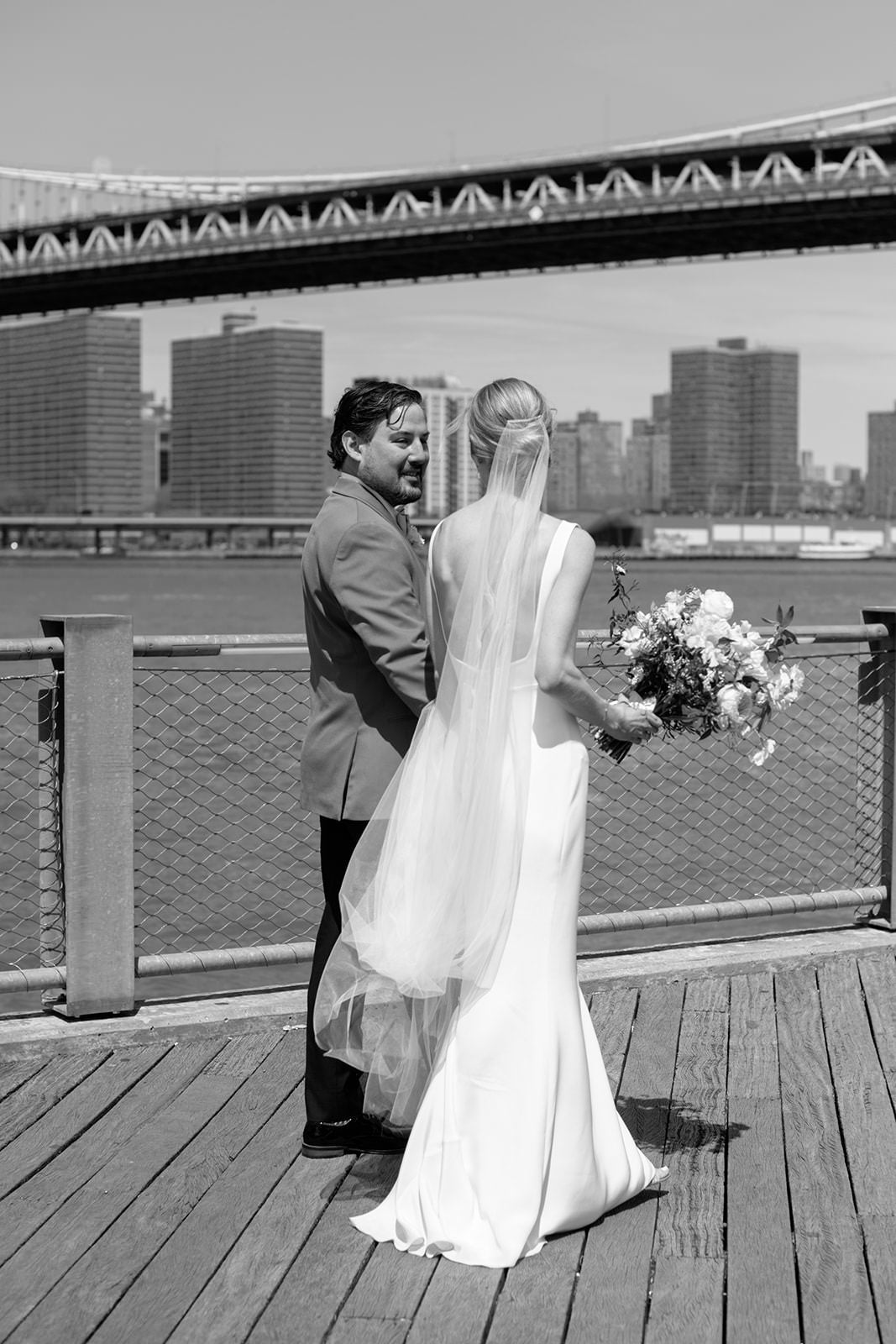 elegant minimalist long wedding veil draped over arm for Brooklyn bridge wedding
