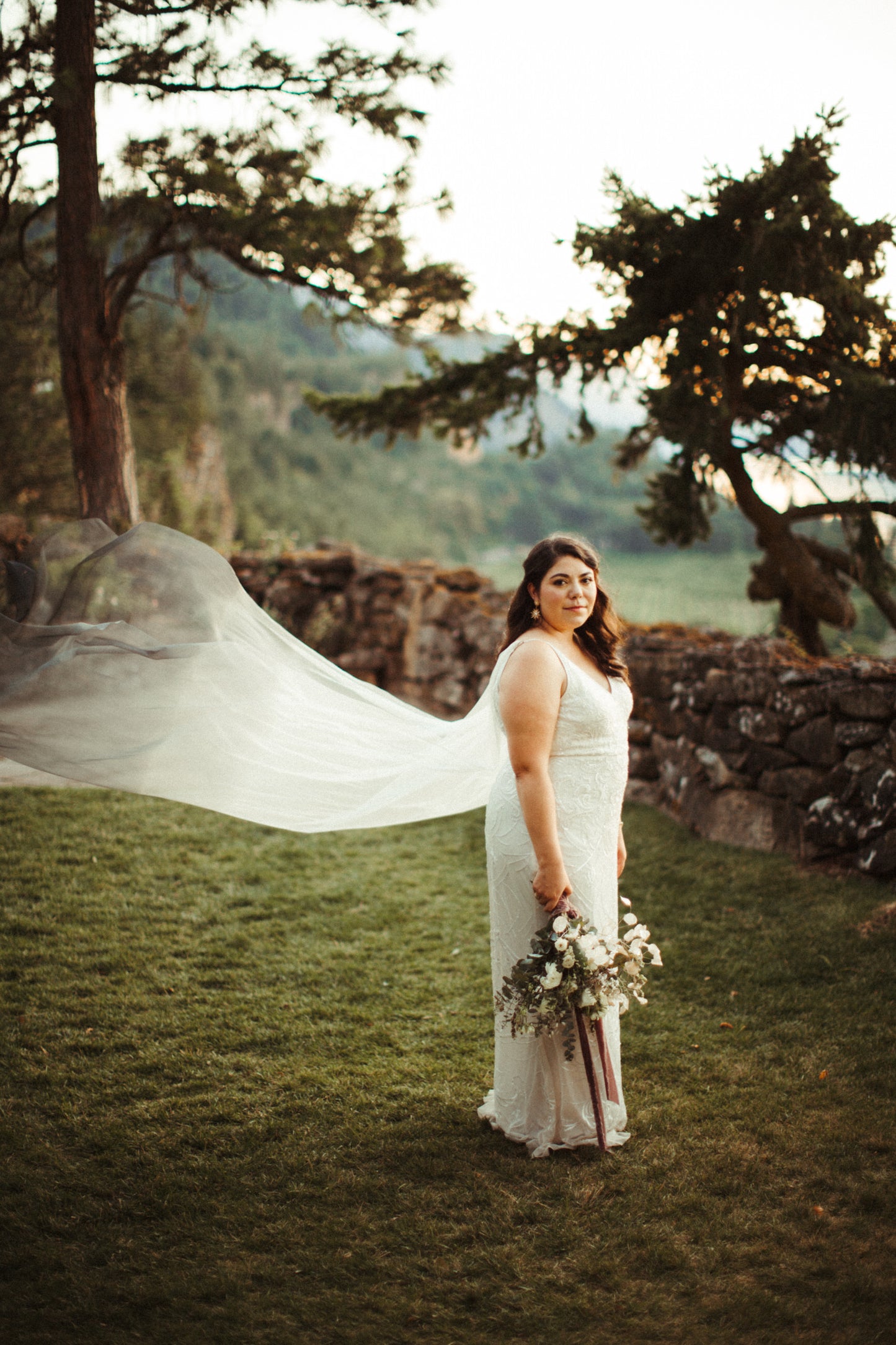 soft feminine bride in lace sheath with dyed blue cape