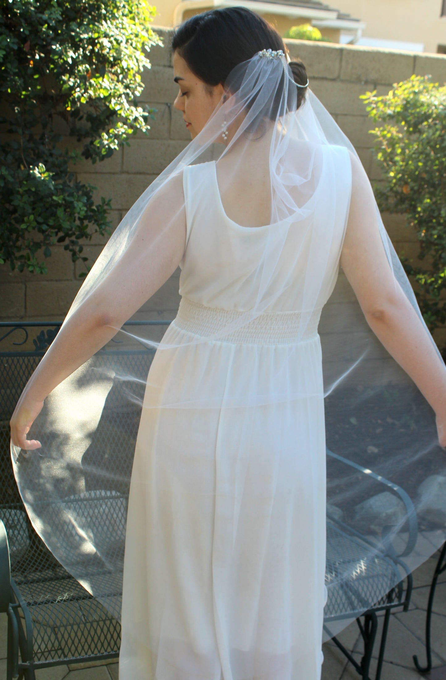 dramatic fingertip length bridal veil draped style with pearl hair combs