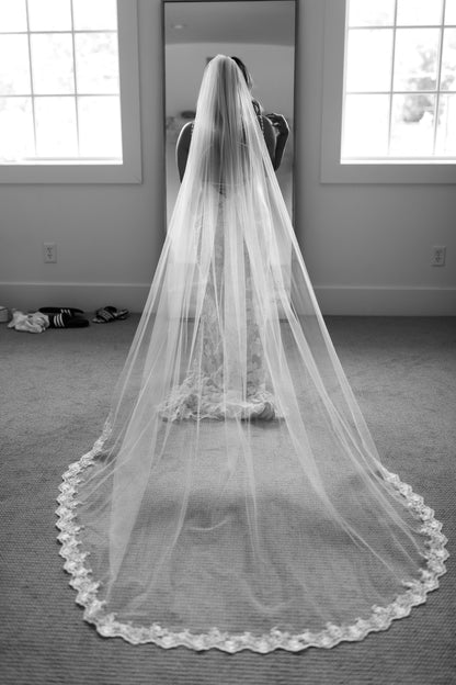 classic black tie monarch long wedding veil with lace trim applique in bride's downdo curled hair