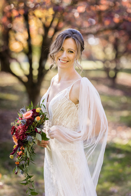 classy bride with tulle wedding sleeves for coverage in fall outdoor wedding