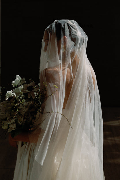 cascade two layer cathedral length wedding veil over sleek wedding updo