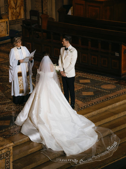 orthodox cathedral bride with royal length wedding veil with bespoke embroidered words on bottom edge