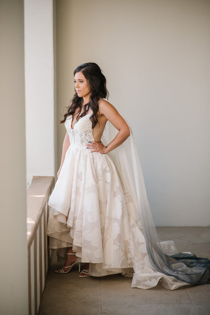 short wedding dress with long cathedral length draped wedding cape in blue