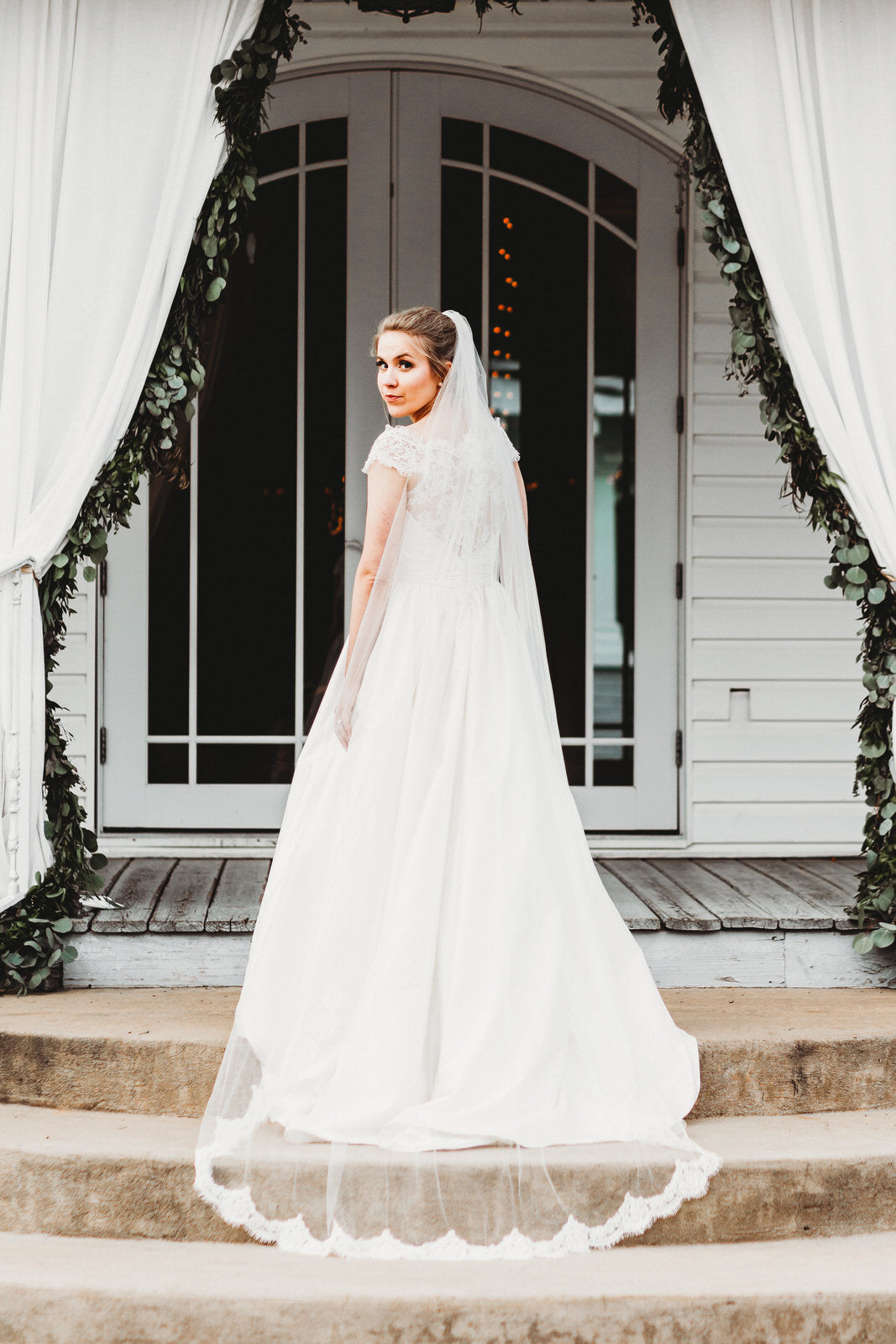 whimsical bride in long chapel length lace veil