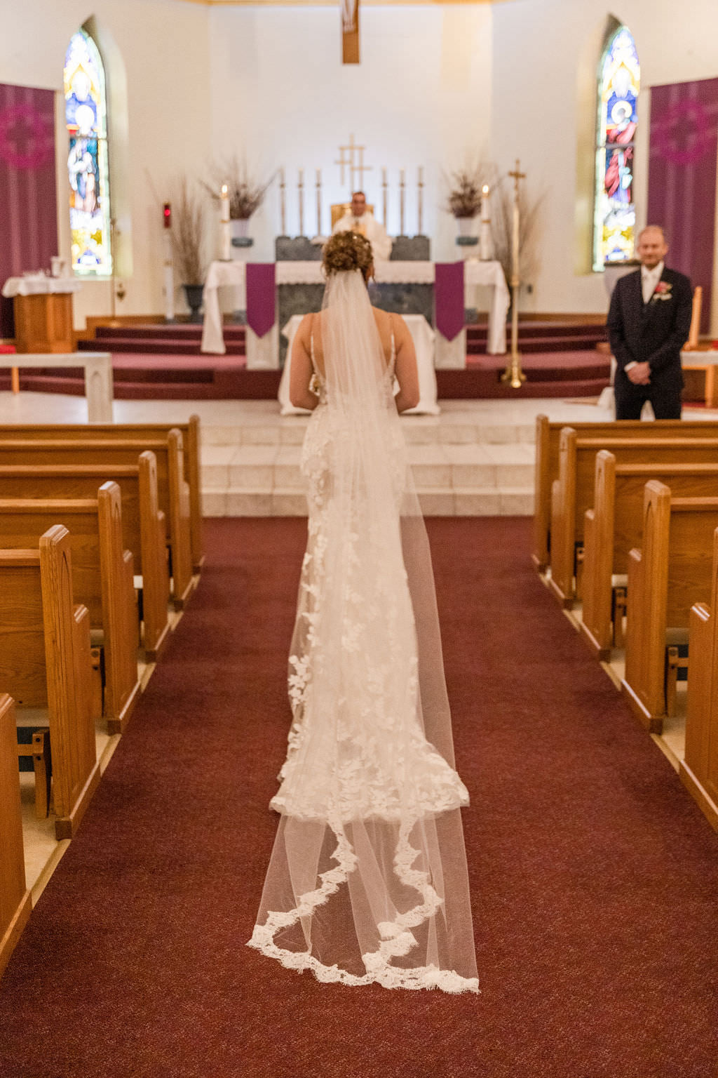 catholic wedding with bride in long floor length wedding veil