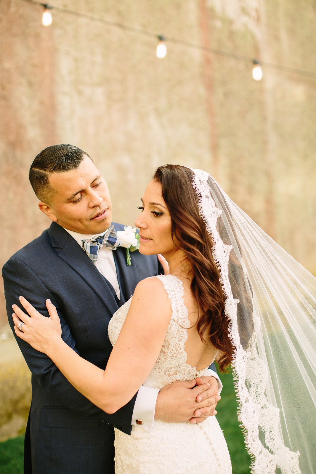 romantic bride with curly hair and lace cathedral mantilla veil