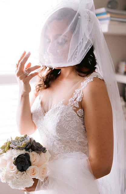 rhinestone beaded birdcage veil over face as bride holds succulent bouquet