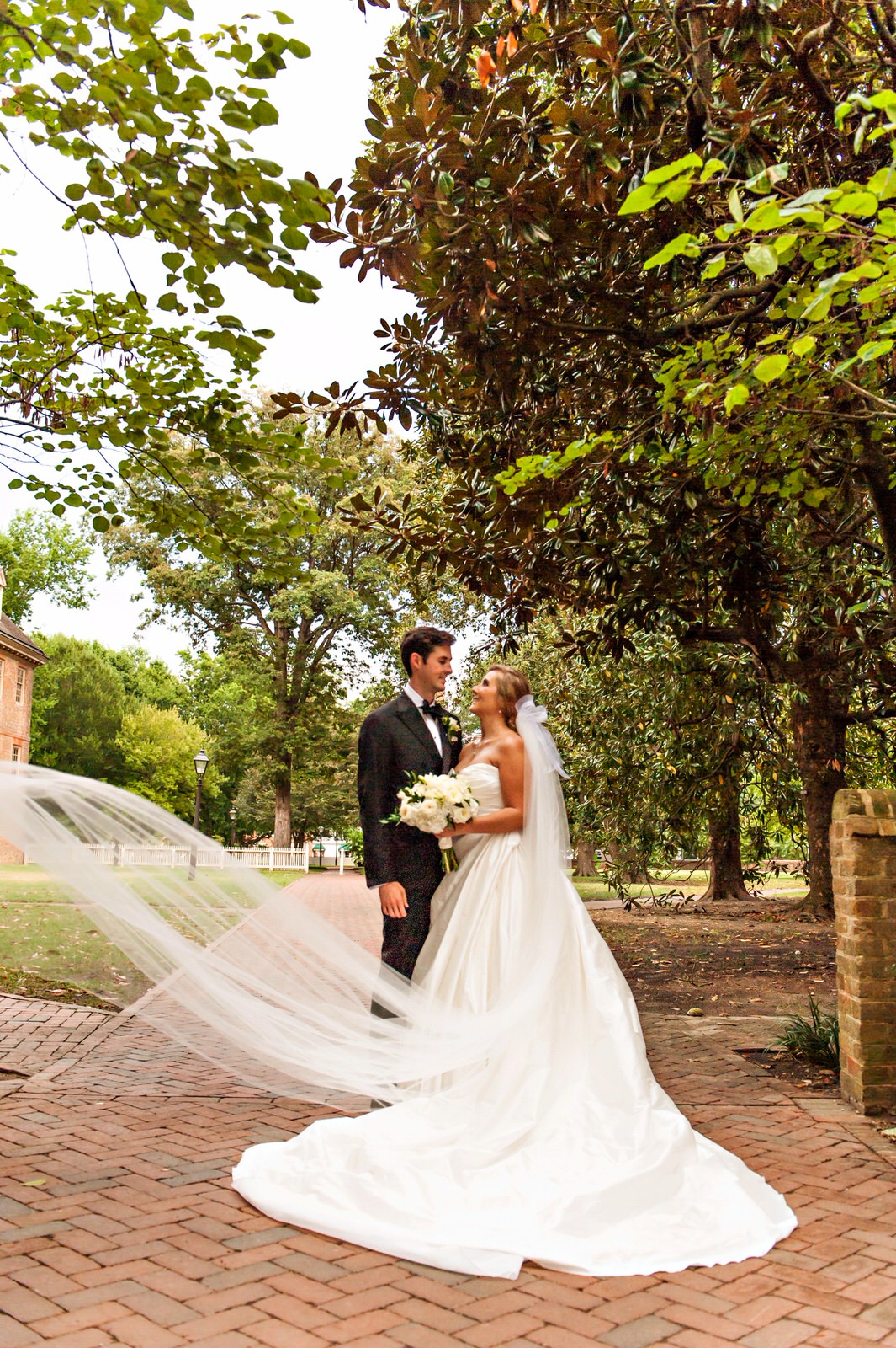 formal wedding portrait with bride in long cathedral veil and silk ballgown