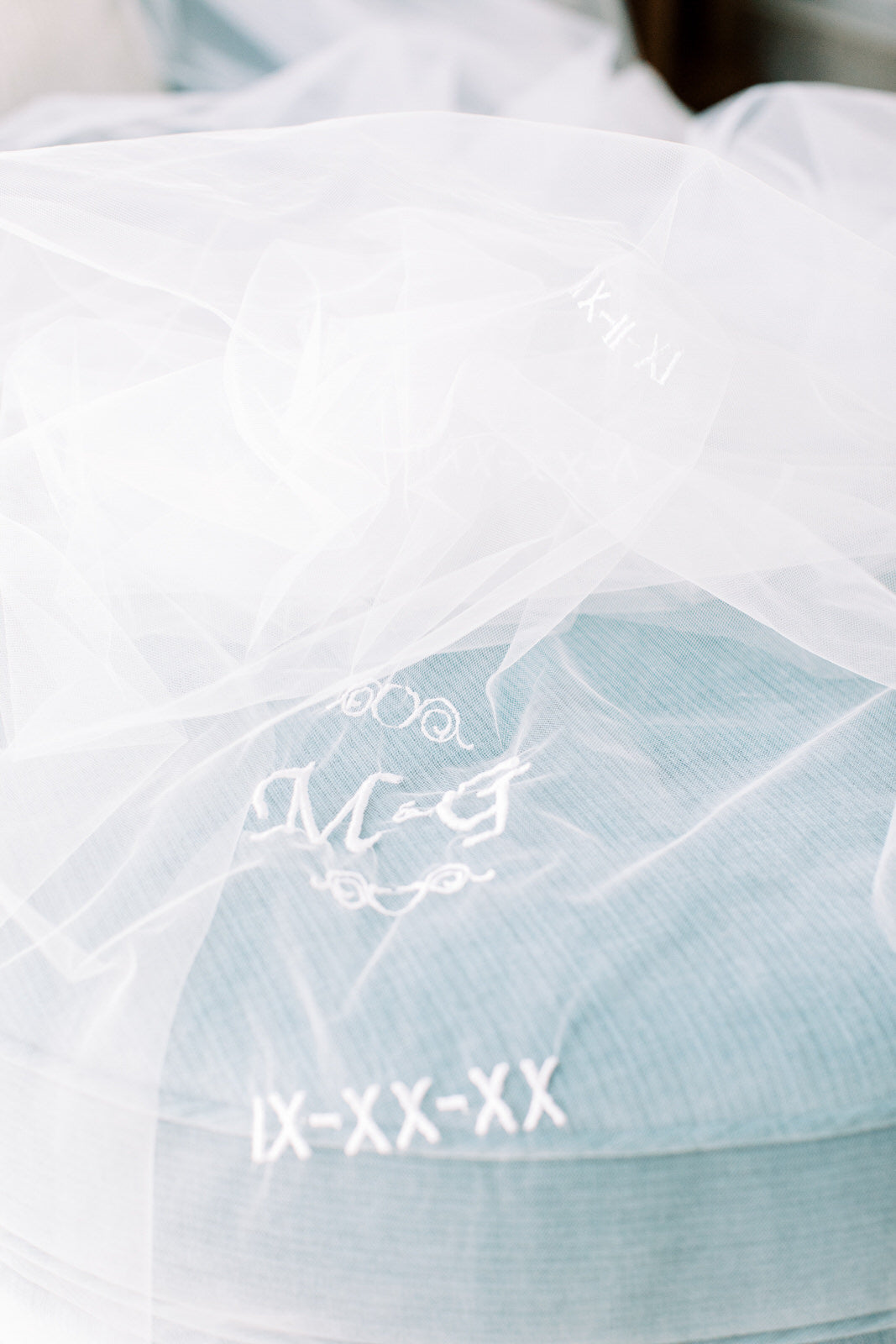 Roman numeral wedding day and married initials on ivory bridal veil
