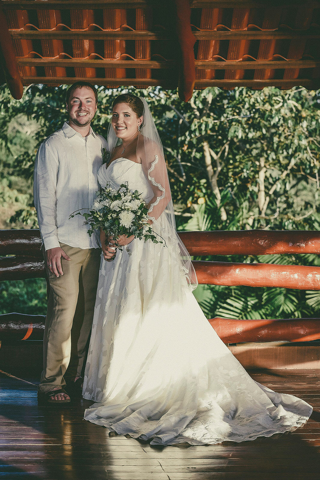 tropical wedding with bride wearing fingertip lace wedding veil