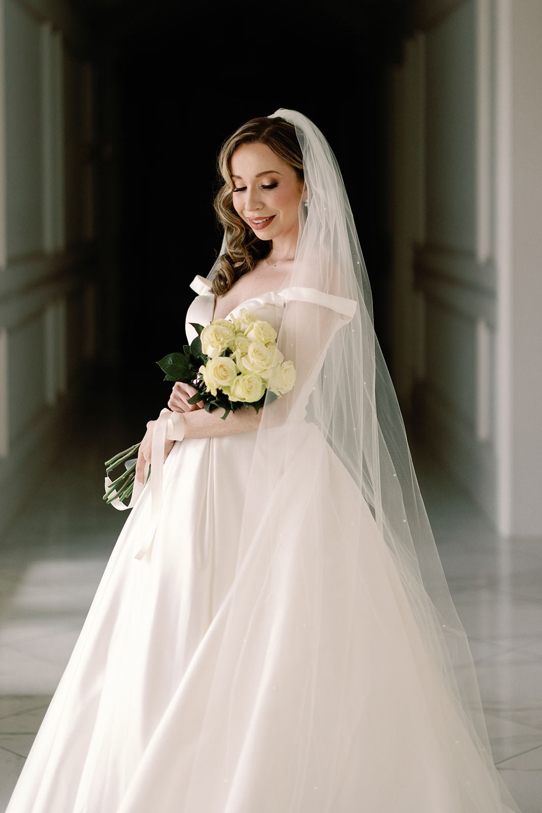 formal black tie wedding with scattered pearl wedding veil and yellow rose bouquet