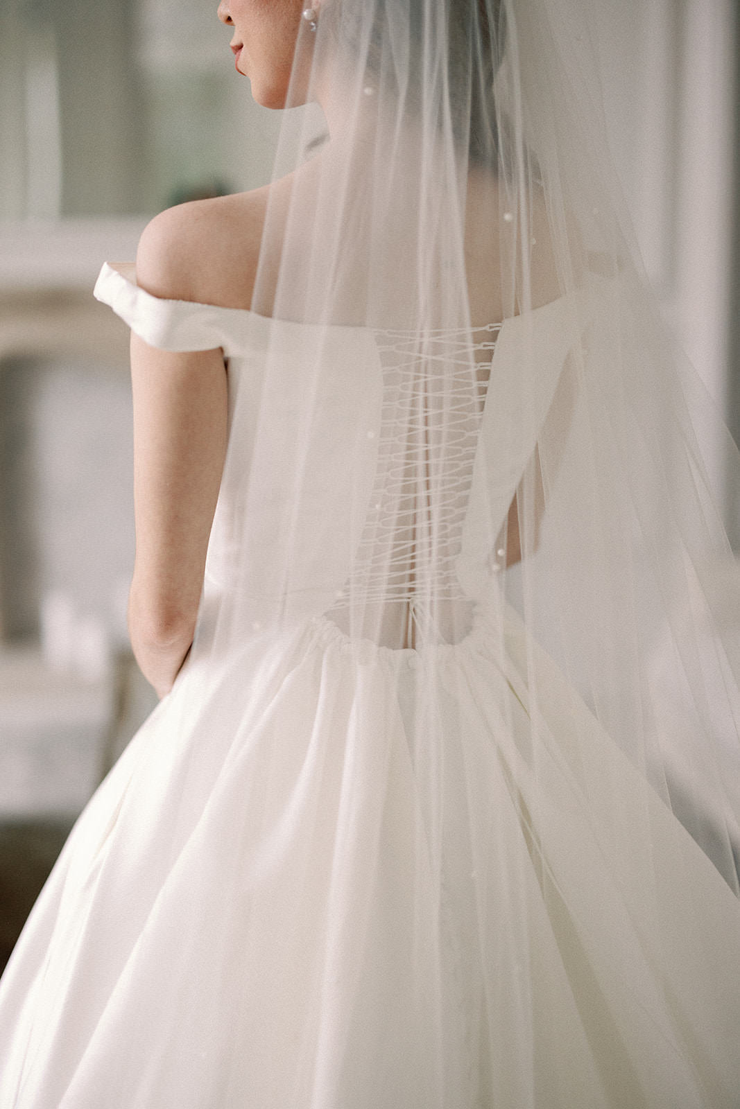 long pearl wedding veil in white with corset gown