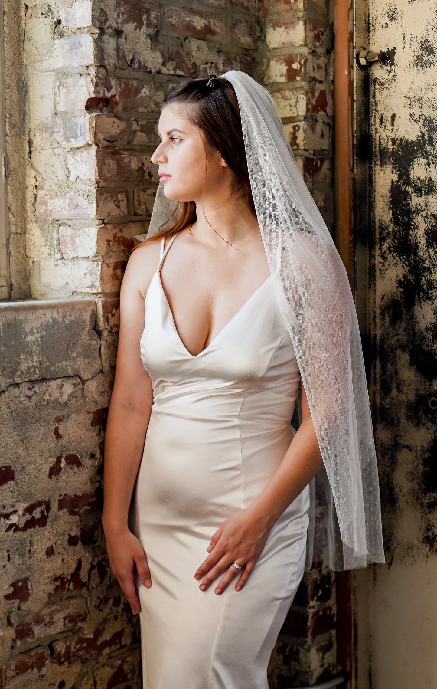 swiss dot fingertip length ivory wedding veil on bride wearing crepe simple dress