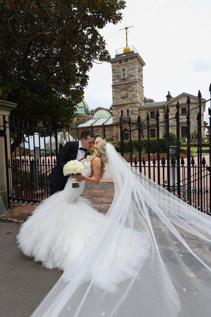 bride and groom with long cathedral length crystal wedding veil