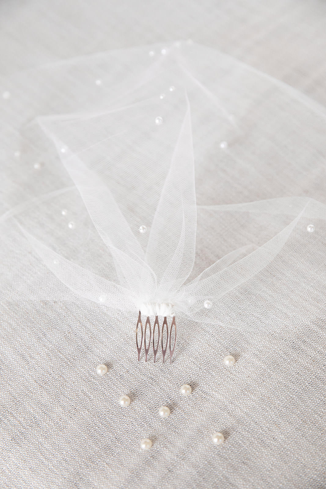 birdcage wedding veil with pearls attached to hair comb